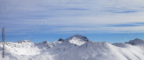Panoramic view on snowy slope in high winter mountains