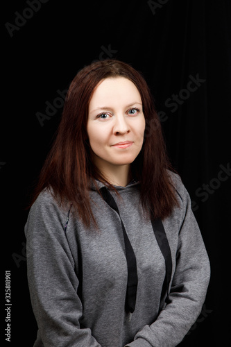 Portrait of young beautiful fitness woman weared grey sport blouse on black background