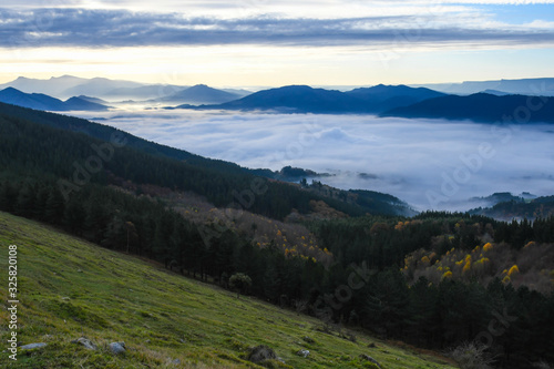 Zalla Valley covered with fog with Mount Gorbea at sunrise photo