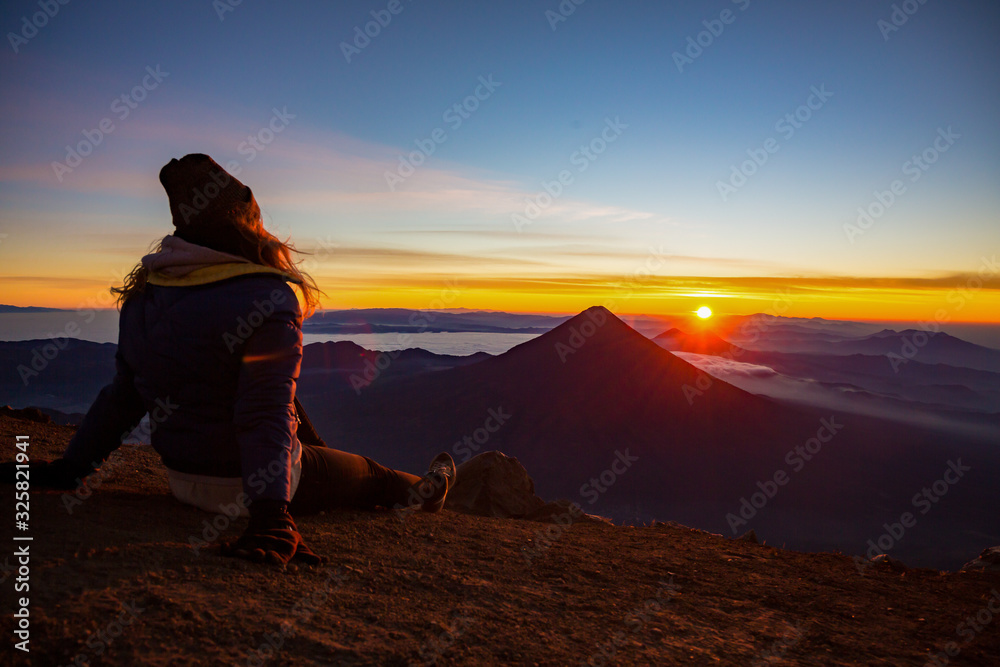 silhouette of girl on top of mountain at sunset silhouette of girl on top of mountain at sunset