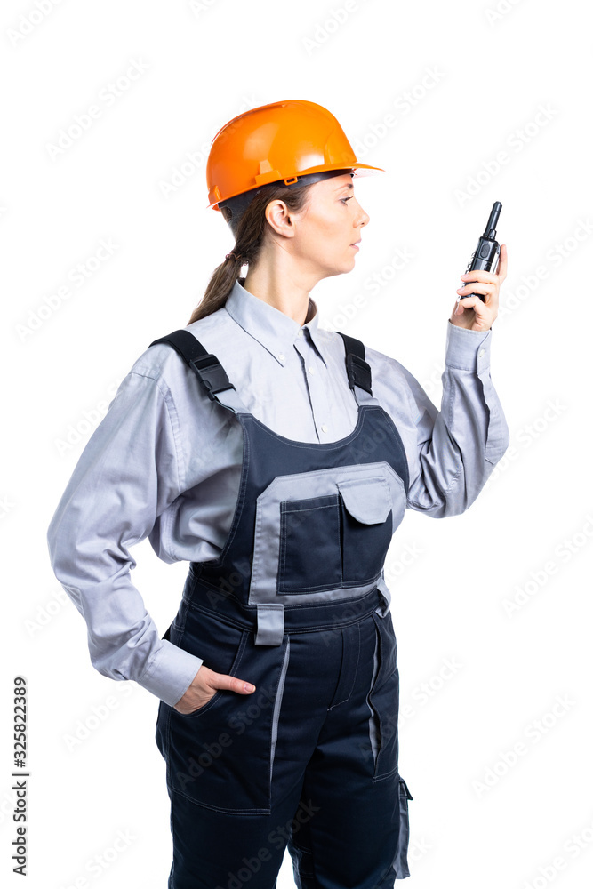 Girl builder talking on the walkie-talkie. isolated