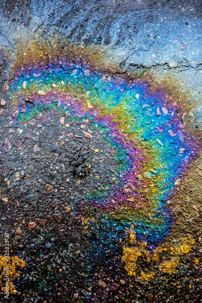 Close up Of Oil Petrol Pollution Rainbow Gasoline Leak on Road