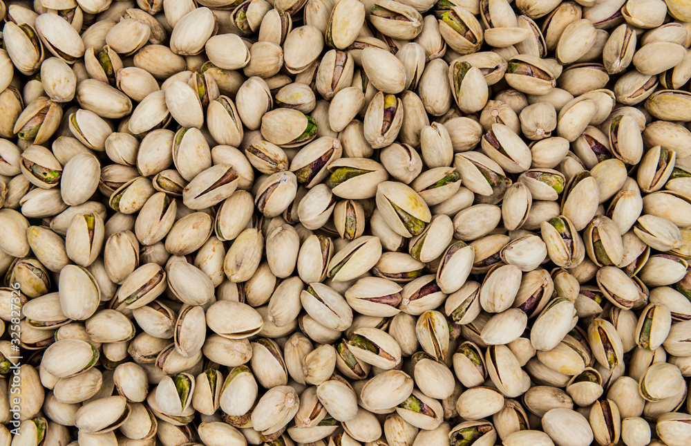 Roasted and salted pistachios top view as a background, texture Roasted and salted pistachios top view as a background, texture