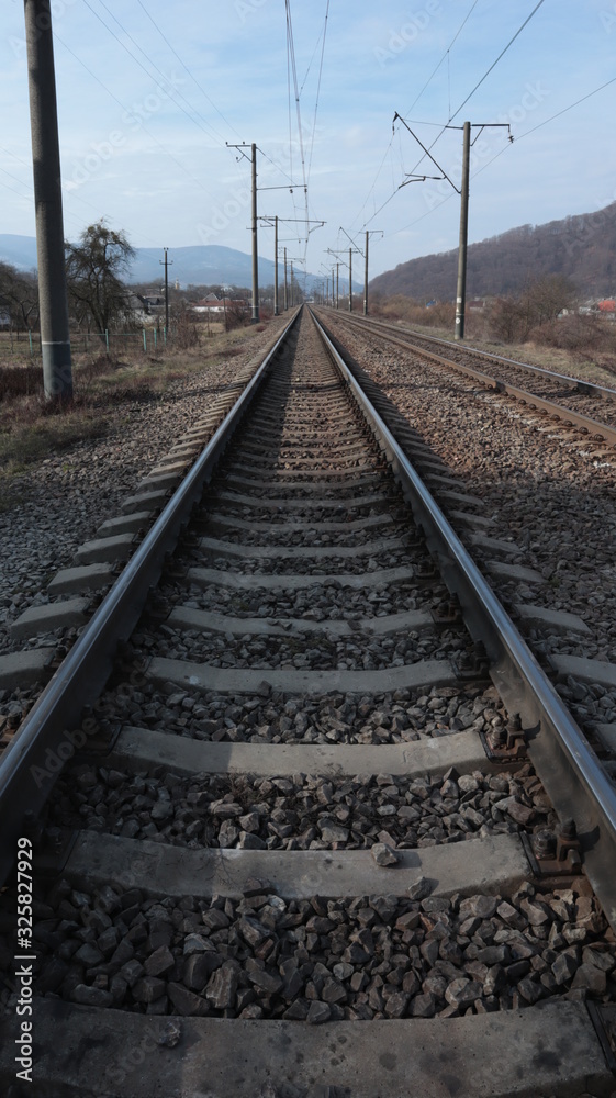 rails, sleepers, railway and poles along the tracks