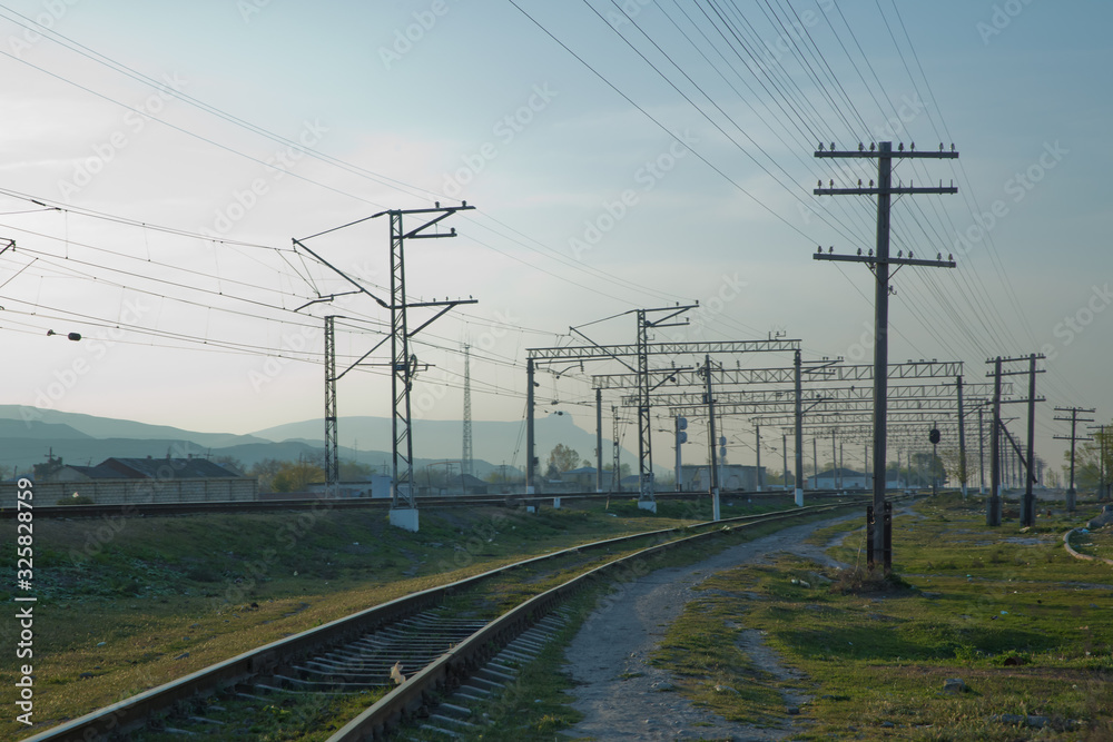 Railroad tracks . Straight railway line . Empty summer railway . local railway and train station .