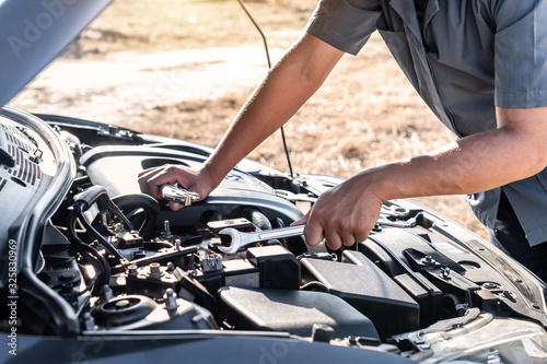Technician hands of car mechanic in doing auto repair service and maintenance worker repairing vehicle with wrench, Service and Maintenance car check