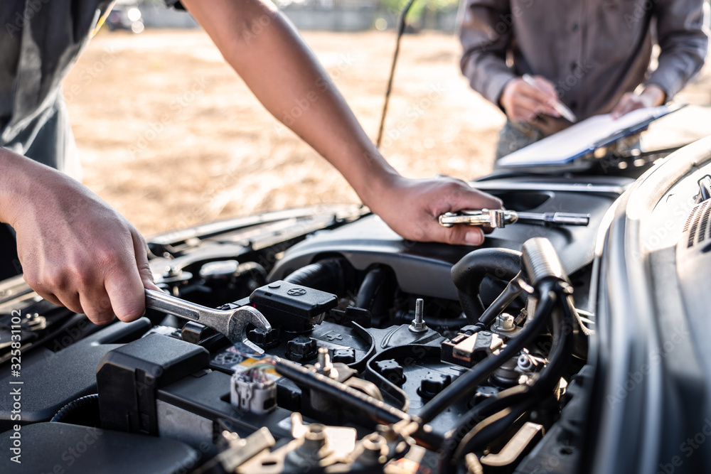 Technician team working of car mechanic in doing auto repair service and maintenance worker repairing vehicle with wrench, Service and Maintenance car check Technician team working of car mechanic in doing auto repair service and maintenance worker repairing vehicle with wrench, Service and Maintenance car check