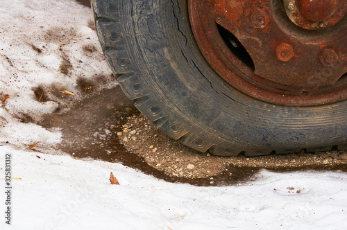 Old flat tire cracked from a big car.