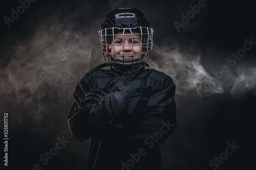 Photography Young blonde fit boy, ice hockey player, posing in a dark studio for a photoshoo