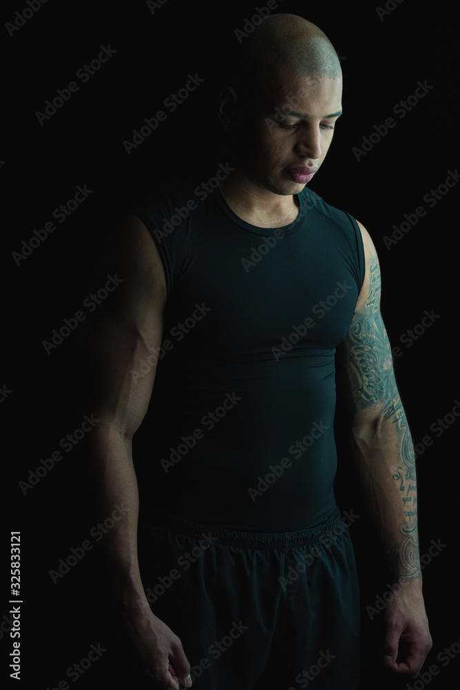 Fototapeta premium Calm tattooed man looking down stock photo