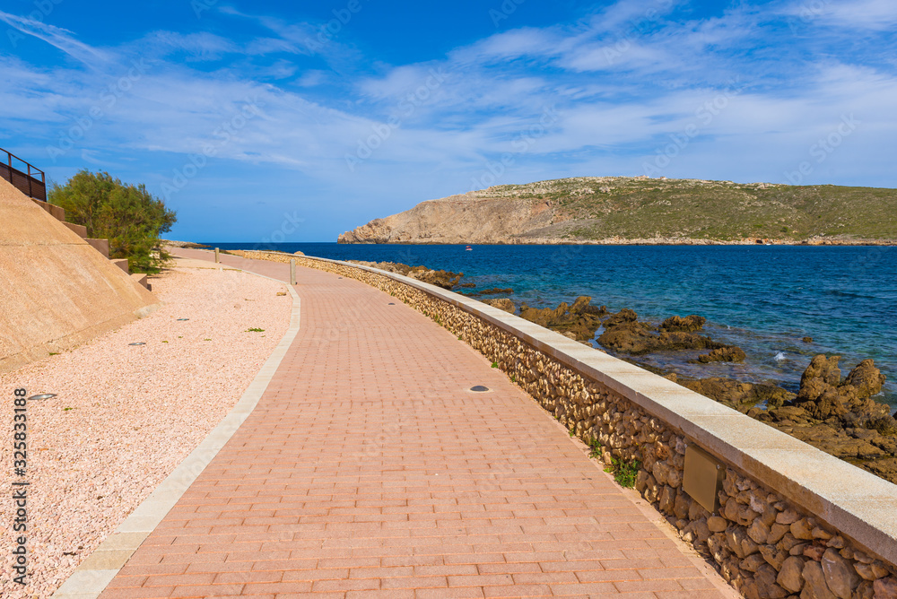 Promenade along the sea in the beautiful town of Fornells in Minorca. Baleares, Spain