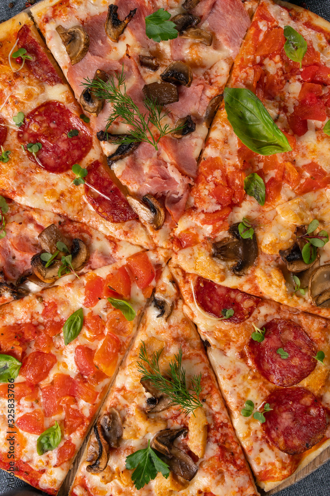 Different slices of pizza on wooden board on the table Different slices of pizza on wooden board on the table
