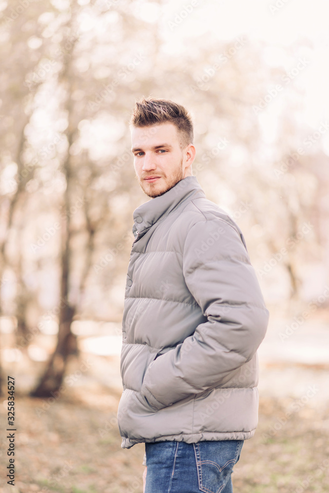 Handsome young man with a beard and stylish haircut in fashionable clothes. Street Lifestyle. Handsome young man with a beard and stylish haircut in fashionable clothes. Street Lifestyle.