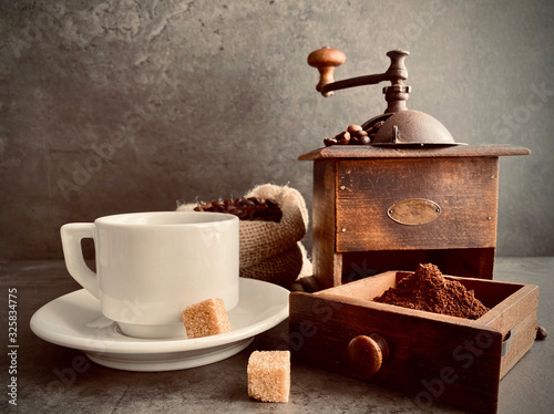 cup of coffee with grinder and beans