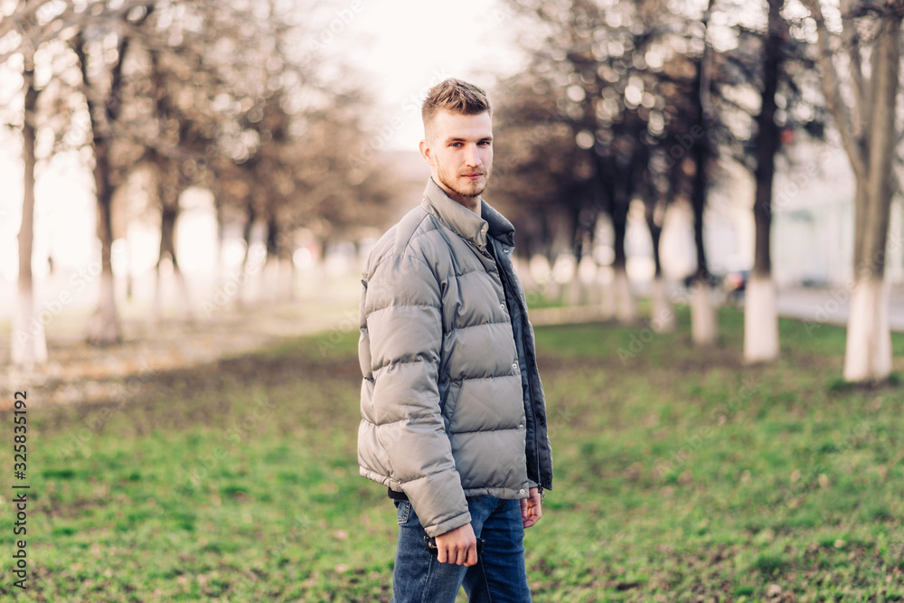 Handsome young man with a beard and stylish haircut in fashionable clothes. Street Lifestyle. Handsome young man with a beard and stylish haircut in fashionable clothes. Street Lifestyle.