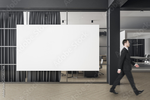 Businessman walking in modern coworking office interior