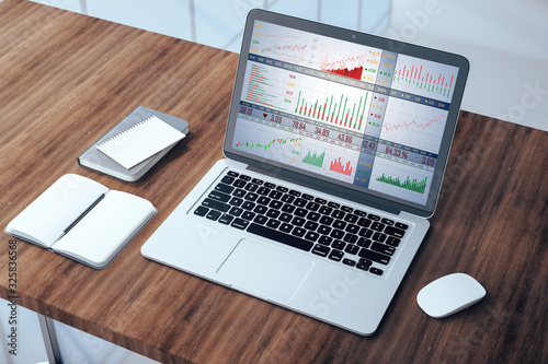 Top view laptop with stock chart on screen