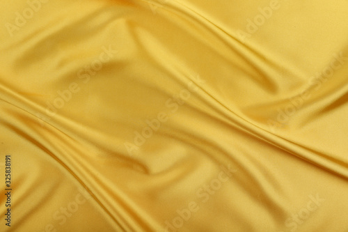 yellow satin with crease. fabric texture