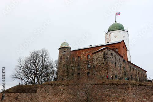 Winter view to medieval Vyborg castle in Russia surrounded by trees