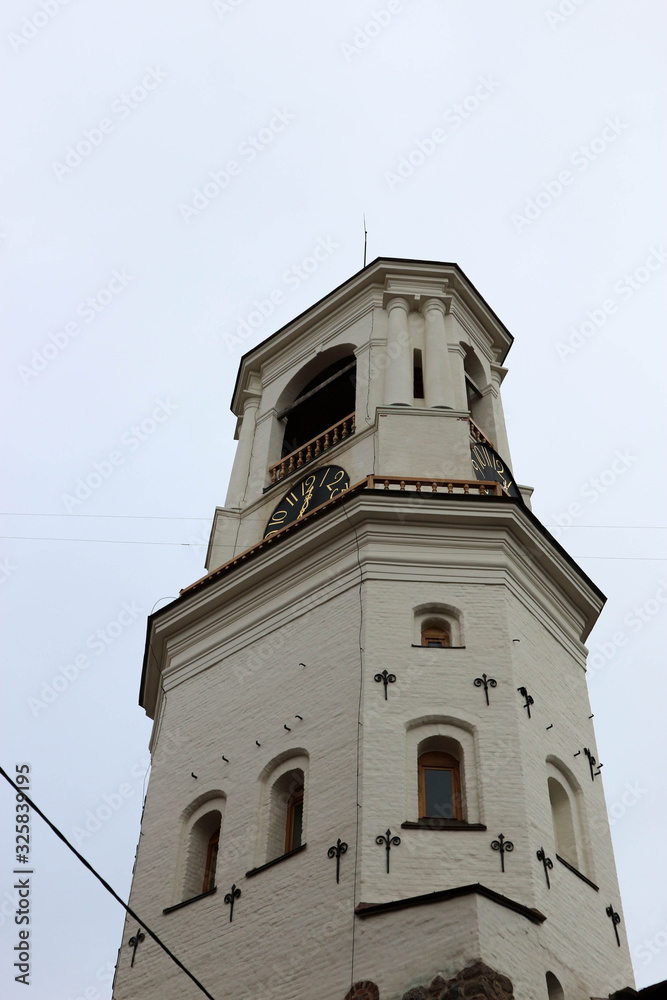 Fototapeta premium old white clock tower in Vyborg, Russia