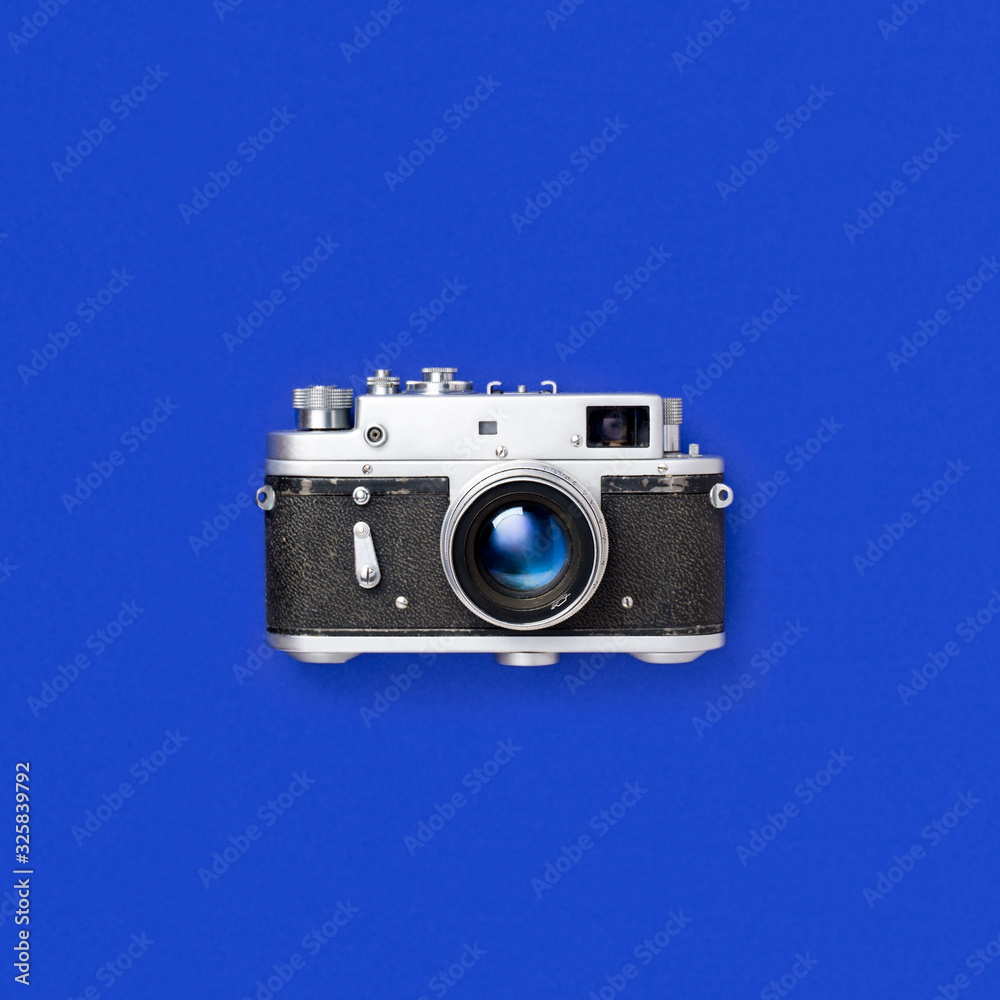 Old film camera on a blue background. Wide format film camera on a blue background. Old soviet camera. lomography