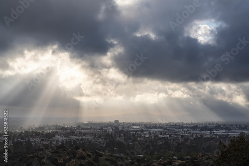 Sunrays breaking through winter storm clouds above the San Fernando Valley in Los Angeles  California.  