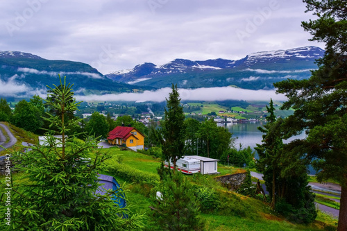 Fog in the mountains. Beautiful Innvikfjord and mountains landscape from Innvik village.  Norway. photo