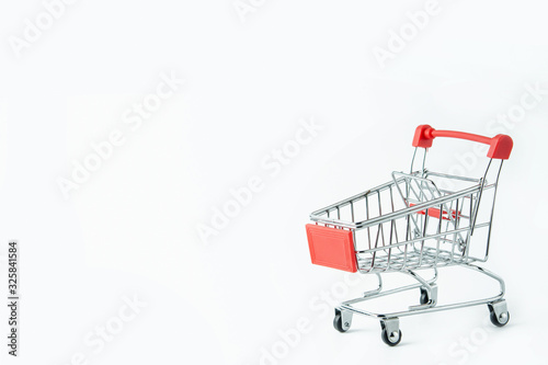 Shopping concept : Red shopping cart on white background with copy space