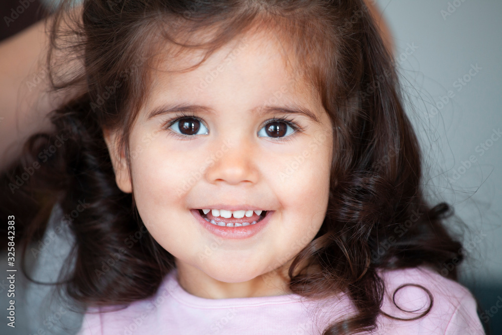 Close up portrait of adorable little girl with a beautiful smile and big brown eyes,happy childhood concept Close up portrait of adorable little girl with a beautiful smile and big brown eyes,happy childhood concept