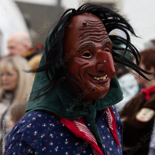 Closeup Portrait of a masked person on a carnival parade photo