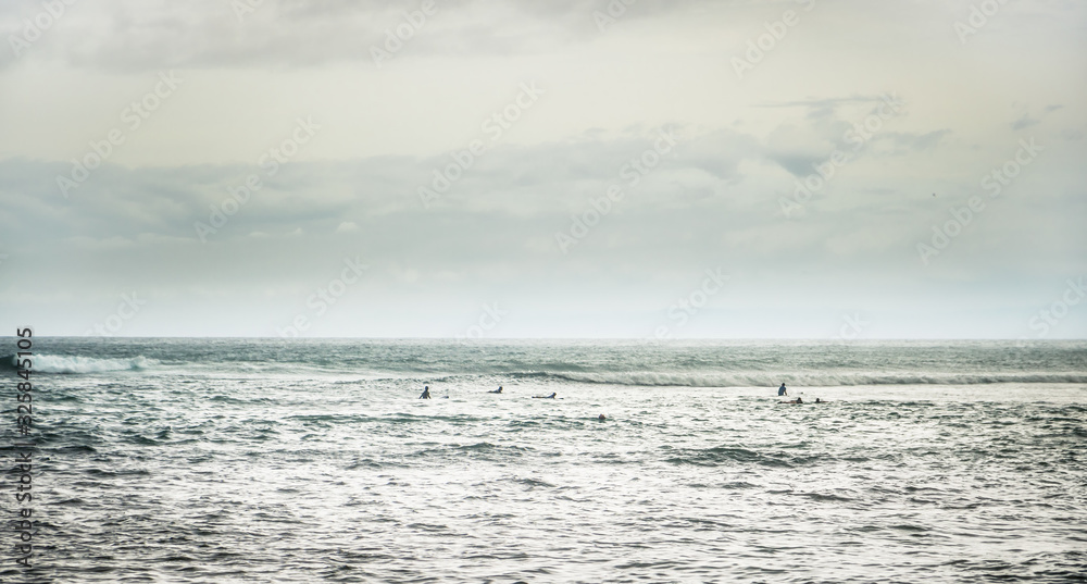 Surfing spot Padang Padang with surfers sea wave on horizon as surfing lifestyle Surfing spot Padang Padang with surfers sea wave on horizon as surfing lifestyle