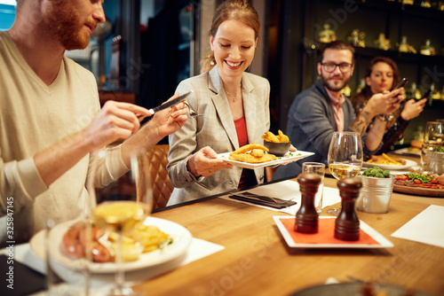 Group of best friends sitting in restaurant  having dinner  drinking wine and having fun.