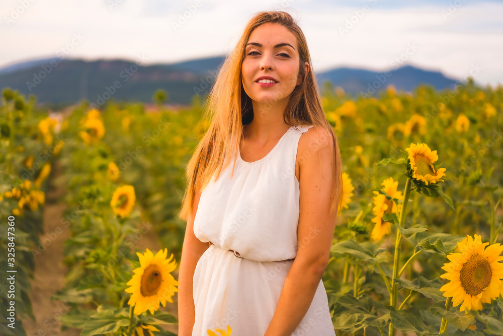 Lifestyle in the city of Pamplona, portrait of a young beautiful Caucasian girl in a field of sunflowers Lifestyle in the city of Pamplona, portrait of a young beautiful Caucasian girl in a field of sunflowers