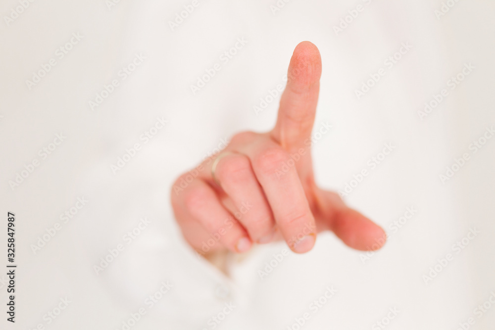 Naklejka premium Index finger of the right hand points forward. Focus on the tip of the finger