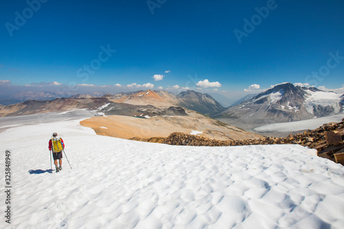 Backpacker crossing glacier, British Columbia, Canada photo