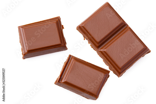 Milk chocolate pieces isolated on white background. top view