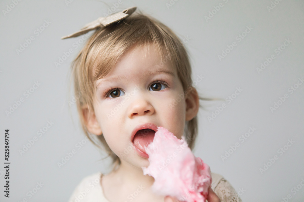 Toddler eating pink cotton candy Stock Photo Adobe Stock