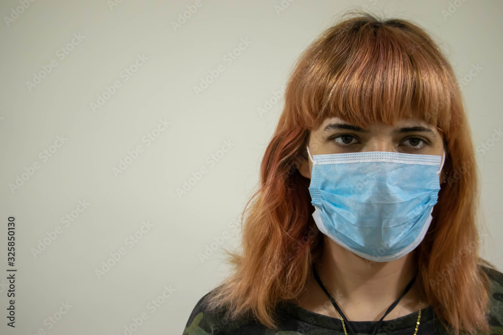 Girl with mask to protect her from Corona virus. Corona virus pandemic. Woman with mask with COVID 19 written.Beautiful girl with medical mask. People are hospitalized for prevention. Coronavirus. Girl with mask to protect her from Corona virus. Corona virus pandemic. Woman with mask with COVID 19 written.Beautiful girl with medical mask. People are hospitalized for prevention. Coronavirus.