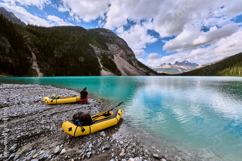 A couple pulls up onto a glacial bar in their rafts on Cirque Lake photo