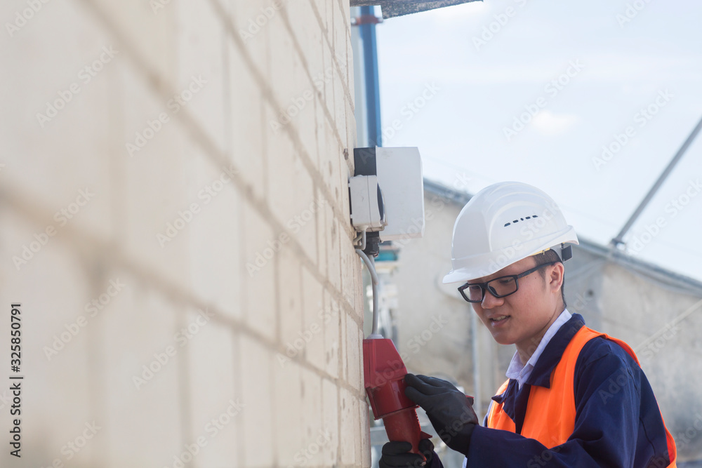 concrete worker checking current of a plug concrete worker checking current of a plug