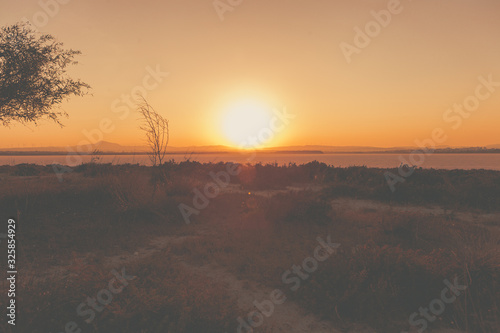 Nice sunset over dry salt lake in Cyprus Larnaca in summer with multilevel background