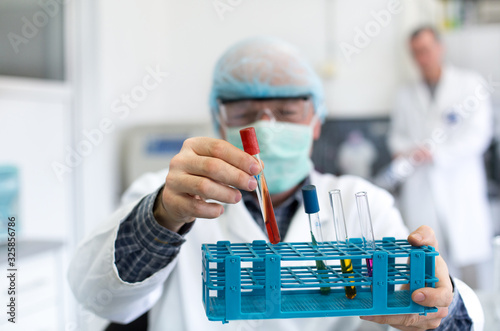 Biologist holding test tube in laboratory