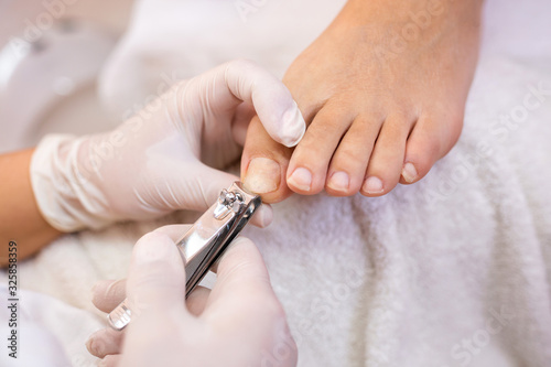 Toe nails cutting with nail clippers photo