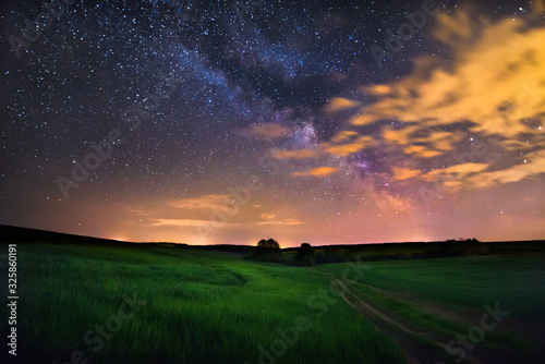 sunset over green field