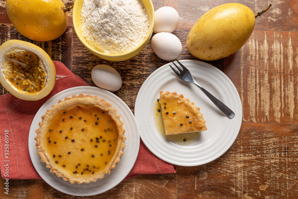 Homemade passion fruit pie with and a golden crust, on wooden background Homemade passion fruit pie with and a golden crust, on wooden background