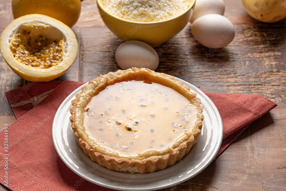 Homemade passion fruit pie with and a golden crust, on wooden background Homemade passion fruit pie with and a golden crust, on wooden background