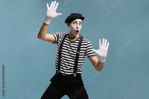 Fotografie Pantomime man touching an imaginary glass