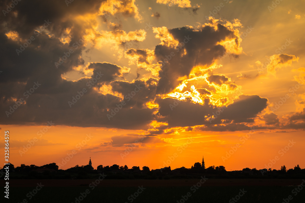Obraz premium Colorful Sunset Setting Over Small Village