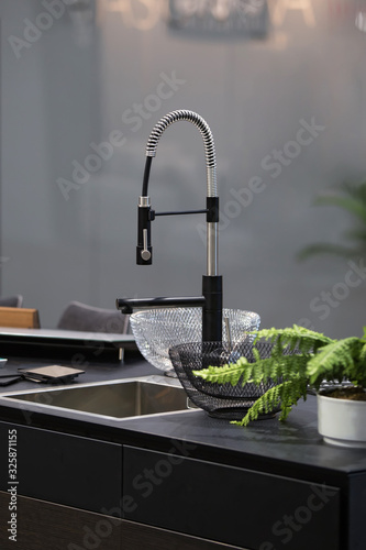 Modern kitchen faucet with remote hose, faucet with pull-out spout. Kitchen in black design