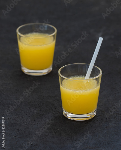 Orange juice in a glass on a dark background